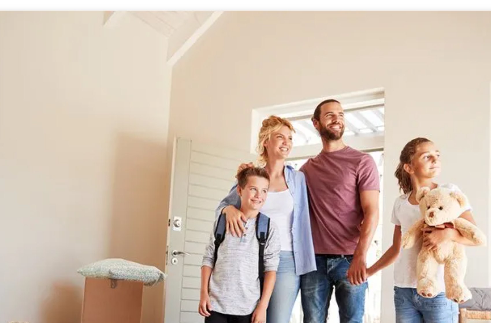 A family standing in an empty home during move-out.